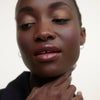 Wonderblush-La Laque Tinted Lip Oil-Makeup-LaLaque-ModelDarkSkin-Bordeaux-The Detox Market | Bordeaux - Deep berry